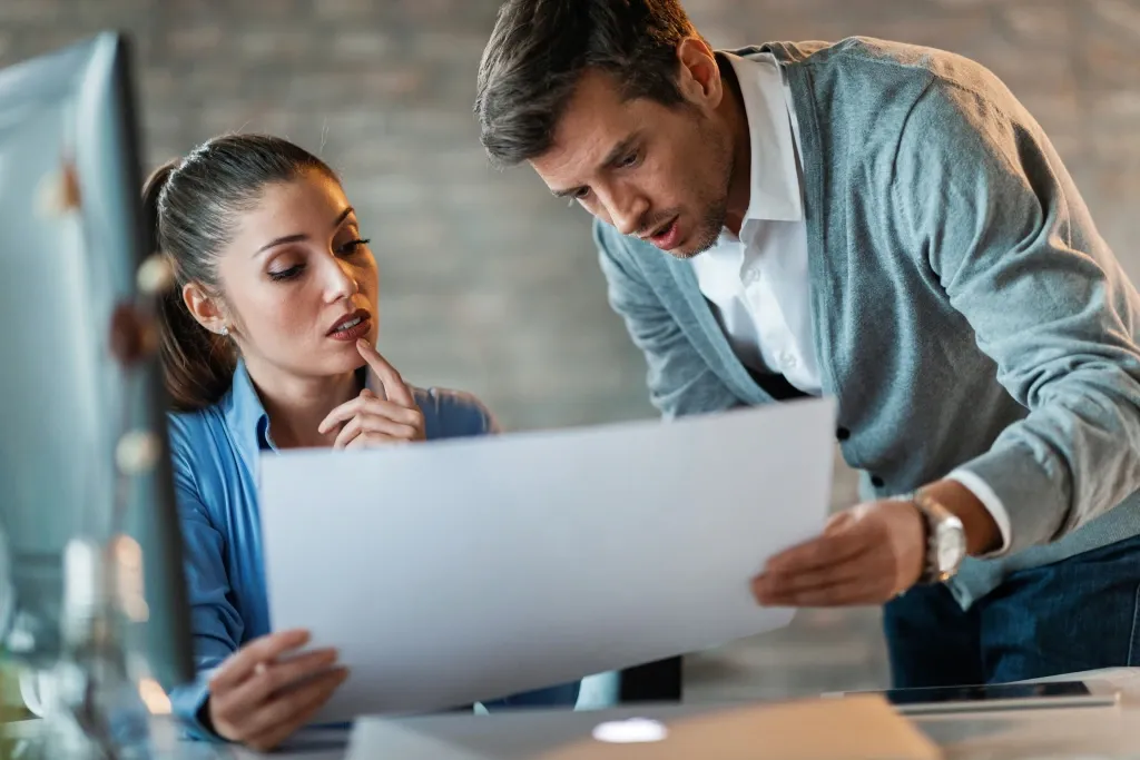 deux personnes coopèrent pour trouver le numéro de contrat d'assurance professionnelle